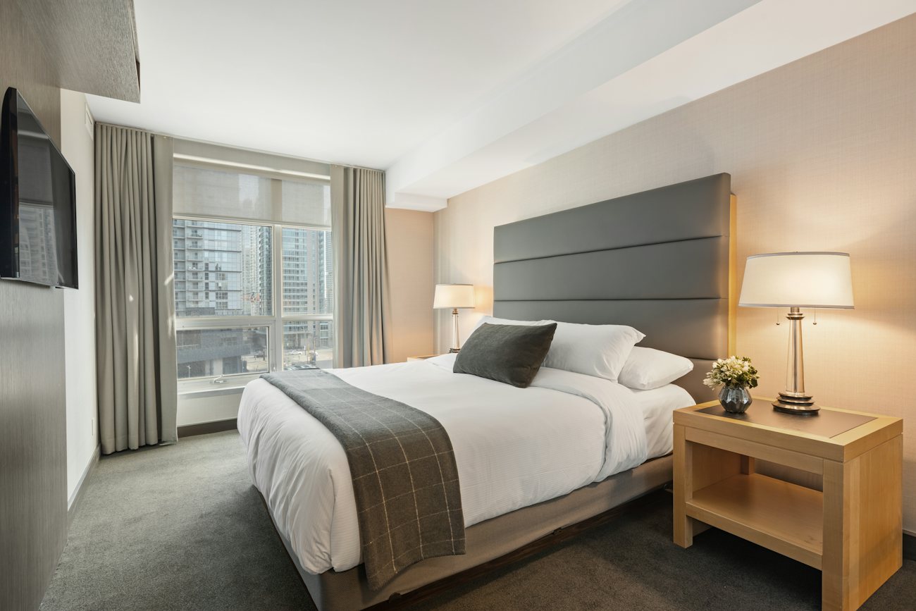 Bright executive room with bed and desk